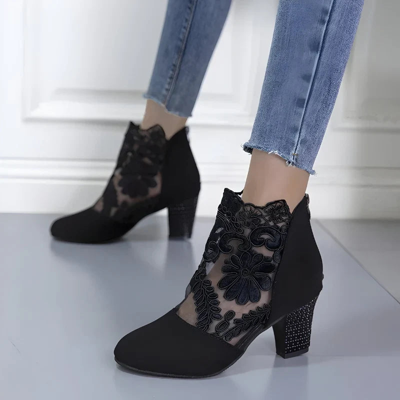 Black orthopedic heeled ankle boots with floral lace mesh and studded block heel