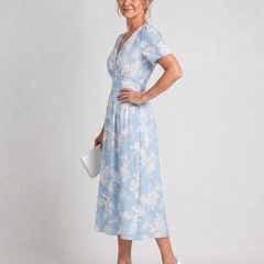 Light blue floral V-neck midi dress with short sleeves and tie-back waist detail