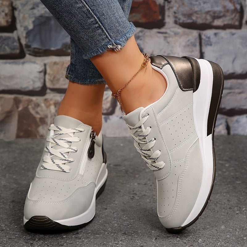 White zip-up comfort sneakers with lace-up front, side zipper, brown heel trim, white sole