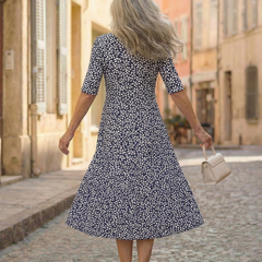 Blue patterned midi dress in A-line cut, back view with short sleeves