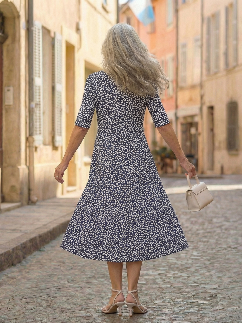 Blue patterned midi dress in A-line cut, back view with short sleeves