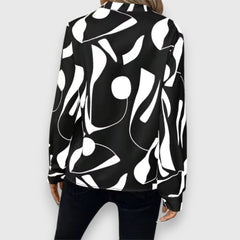 Black long-sleeve V-neck blouse, back view, bold white abstract pattern