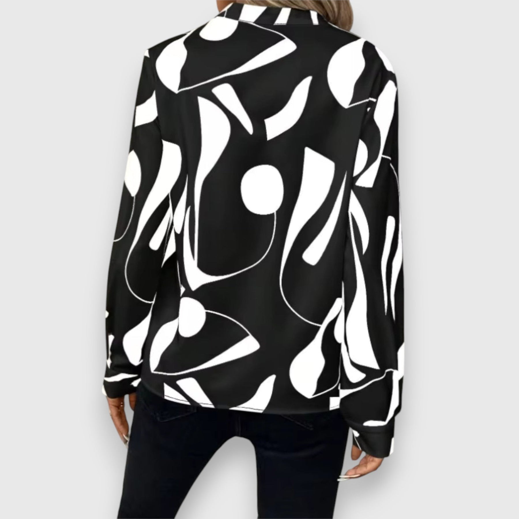 Black long-sleeve V-neck blouse, back view, bold white abstract pattern