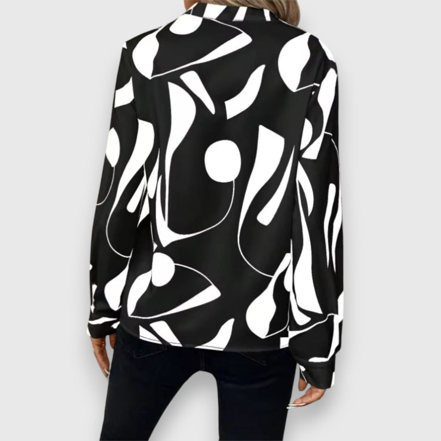 Black long-sleeve V-neck blouse, back view, bold white abstract pattern