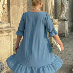 Blue ruffle day dress back view with gathered hem and elbow-length puff sleeves