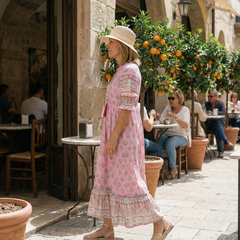 Pink V-neck tiered midi dress with short puff sleeves, side view, patterned print