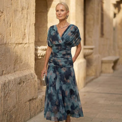 Teal-blue V-neck maxi dress with wrap bodice and flowing skirt