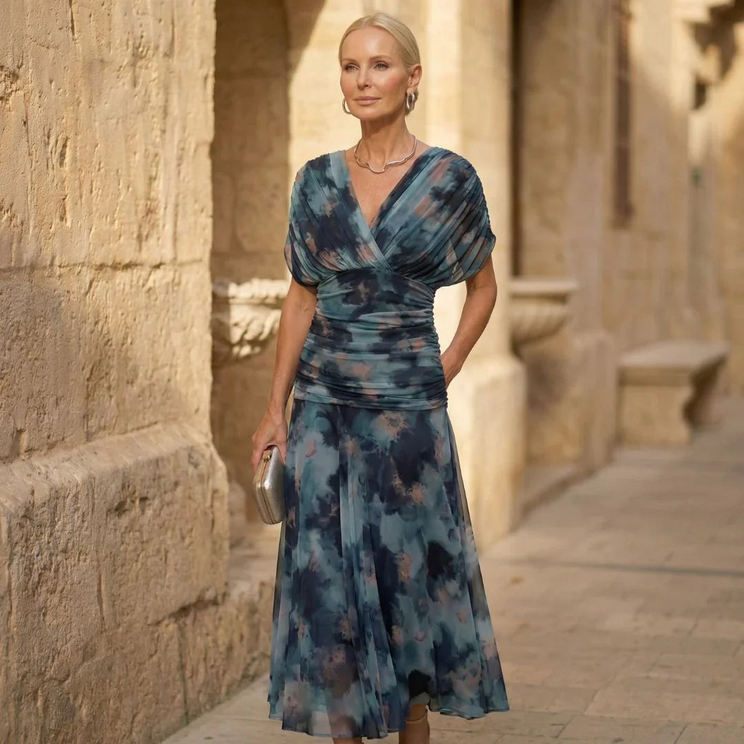 Teal-blue V-neck maxi dress with wrap bodice and flowing skirt