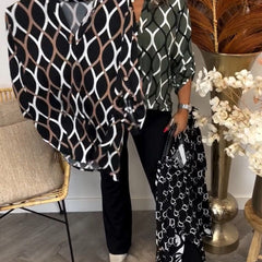 Navy blouse with white linked oval pattern and roll-cuff sleeves, button front
