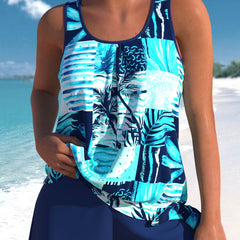 Blue tankini set with tropical print and striped panels, paired with swim shorts