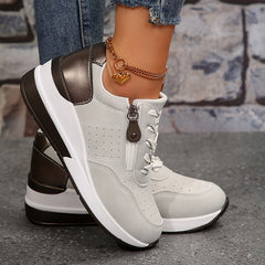 White zip-up comfort sneakers with lace-up front, side zipper, brown heel accents, chain charm