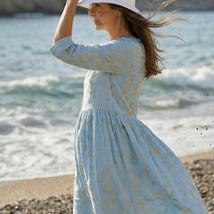 Sky blue leaf-print midi dress with gathered waist and three-quarter sleeves, round neckline