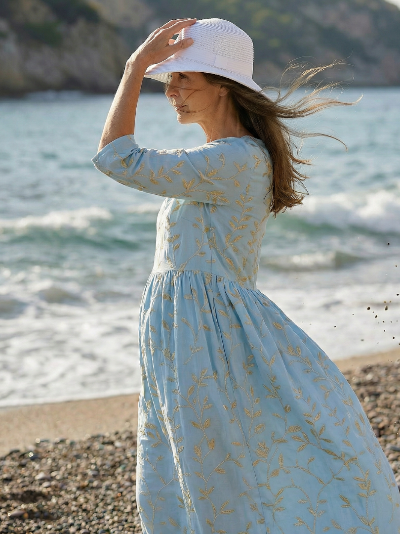 Sky blue leaf-print midi dress with gathered waist and three-quarter sleeves, round neckline