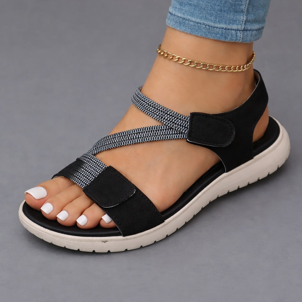 Black open-toe sandals with two hook-and-loop straps, ankle chain, cushioned sole
