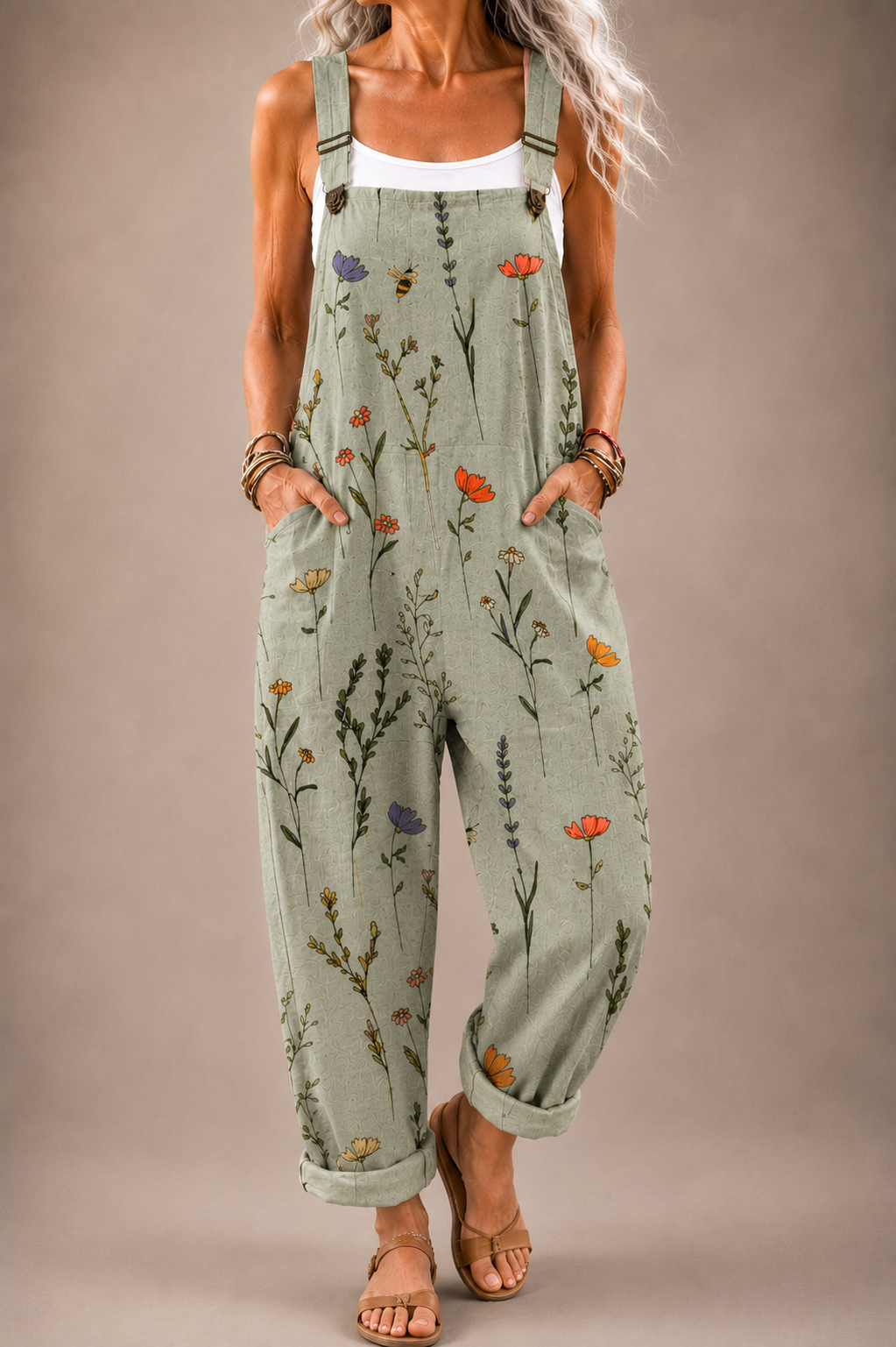 Sage green floral printed overalls with adjustable straps and front pockets