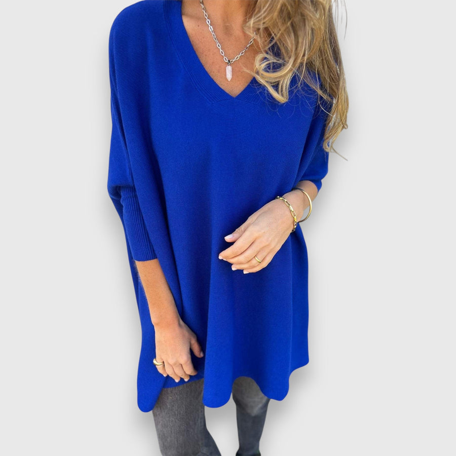Blue oversized V-neck sweater with loose knit and long sleeves.