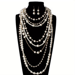 Pearl statement necklace with multi-strand drape and matching earrings on mannequin