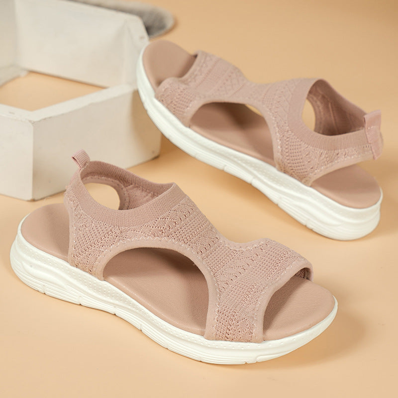 Light pink knit slip-on sandals with cushioned footbed and white rubber sole