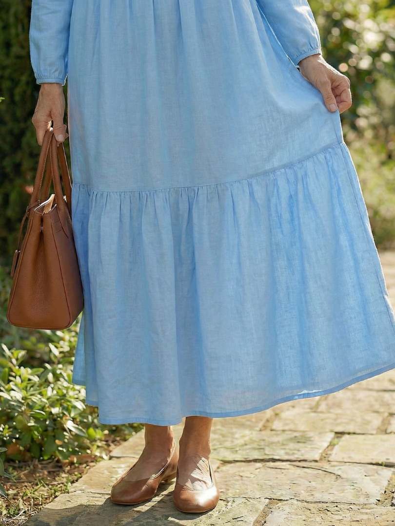 Light blue tiered dress skirt with gathered ruffle hem and long sleeves