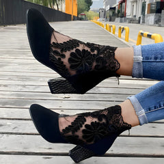 Black orthopedic heeled ankle boots with floral lace mesh, glitter heel detail, and high block heel