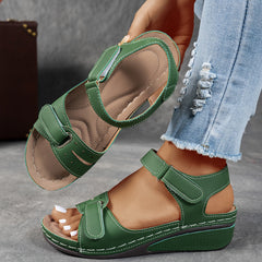 Green leather open-toe sandals with two hook-and-loop straps and cushioned platform sole