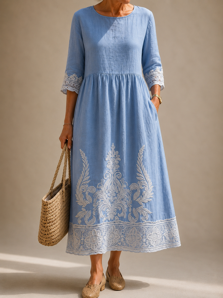 Light blue long-sleeve dress with floral embroidery and lace-trim hem