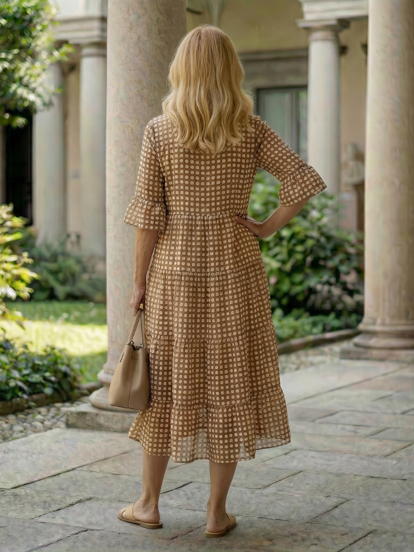 Brown polka dot tiered midi dress back view with short sleeves and tiered hem