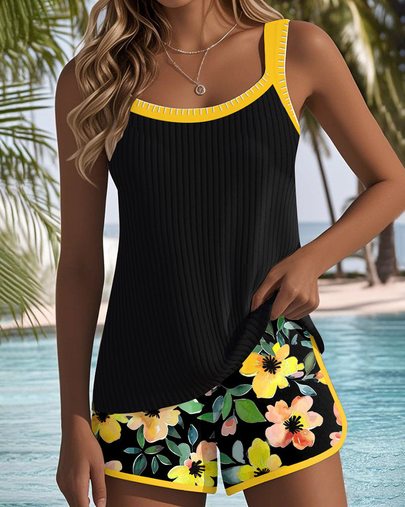 Two-piece beach tankini set with black tank top and yellow trim floral shorts