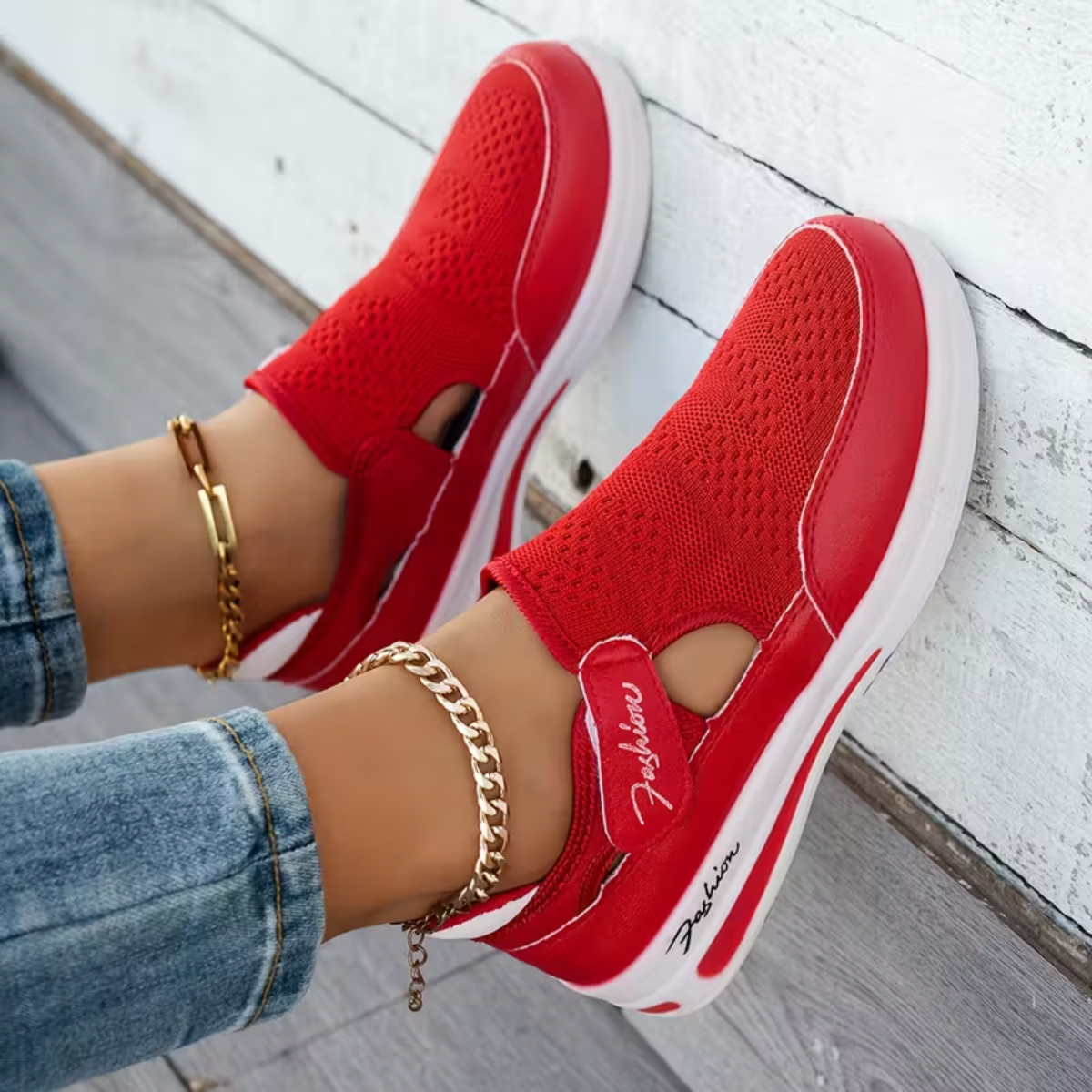 Red perforated comfort sneakers with side cutout, elastic strap, and white sole