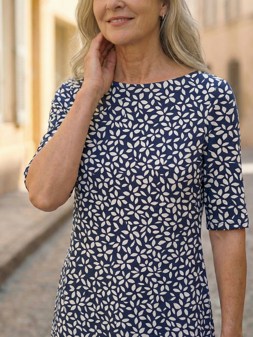 Blue patterned dress close-up with round neckline and short sleeves