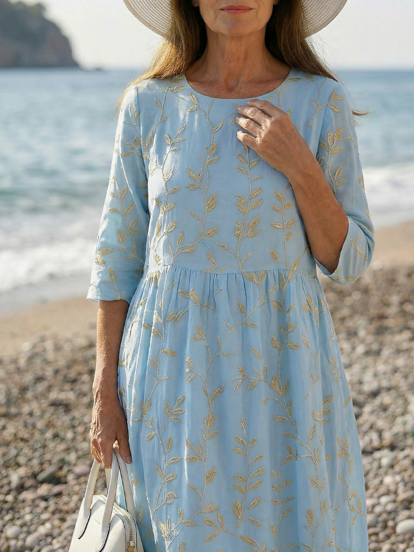 Sky blue leaf-pattern midi dress with round neckline, three-quarter sleeves, gathered waist detail