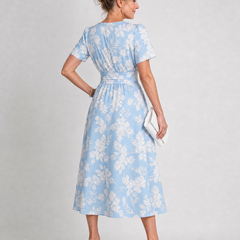 Light blue floral V-neck midi dress shown from back with short sleeves and waist gather
