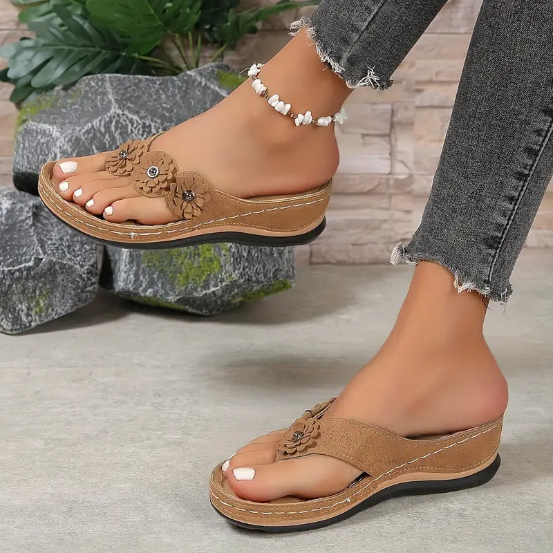 Brown comfort sandals with embossed floral applique and white beaded ankle strap