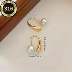 Gold-tone arc hoop earrings with white pearl drop, curved open ring design