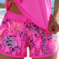 Pink ocean-print swim shorts with drawstring tie and starfish and turtle motifs