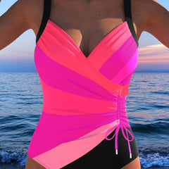 Pink surplice swimsuit with diagonal colorblocking, ruched front and side drawstring