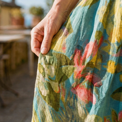 Painterly canvas dress fabric close-up in teal with yellow and coral brush marks