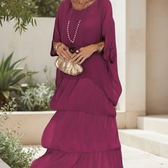 Vivid pink tiered long-sleeve dress with draped overlay and round neckline