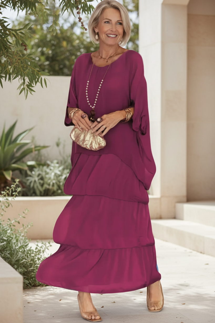Vivid pink tiered long-sleeve dress with draped overlay and round neckline