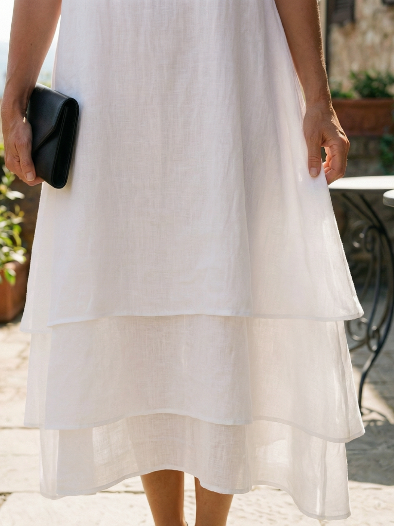 White layered midi skirt with tiered ruffle levels and lightweight fabric