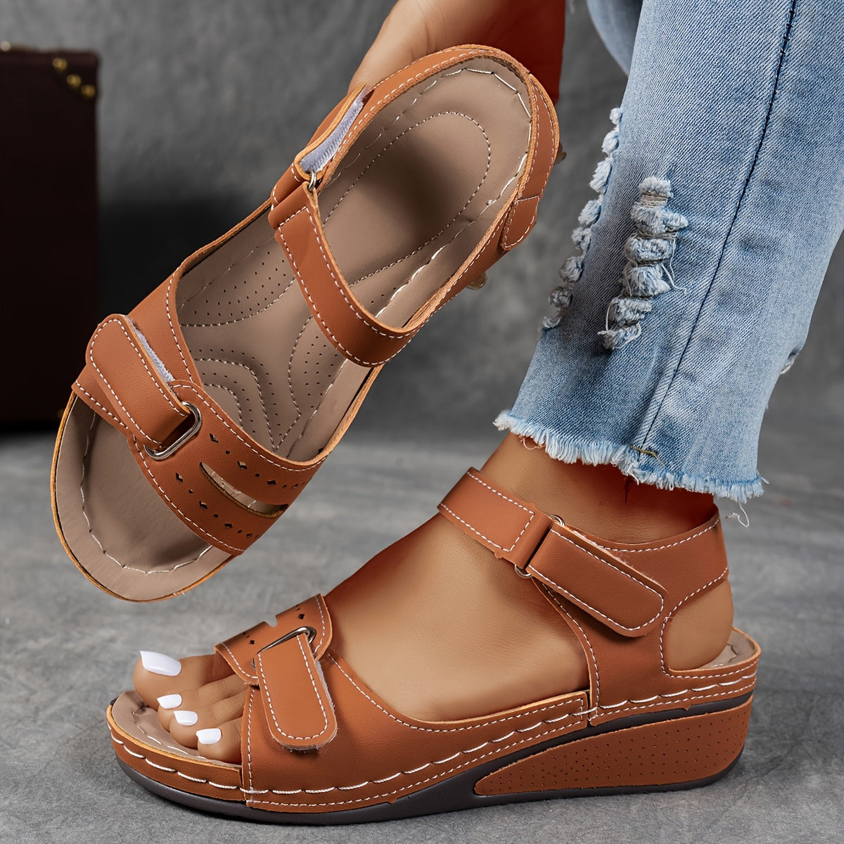 Brown leather open-toe sandals with two hook-and-loop straps and cushioned platform sole