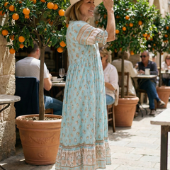 Sky blue V-neck tiered midi dress with short puff sleeves, small floral print