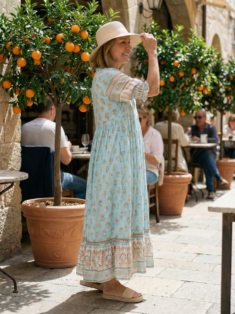 Sky blue V-neck tiered midi dress with short puff sleeves, small floral print