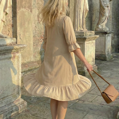 Beige ruffle day dress back view with tiered hem and elbow puff sleeves