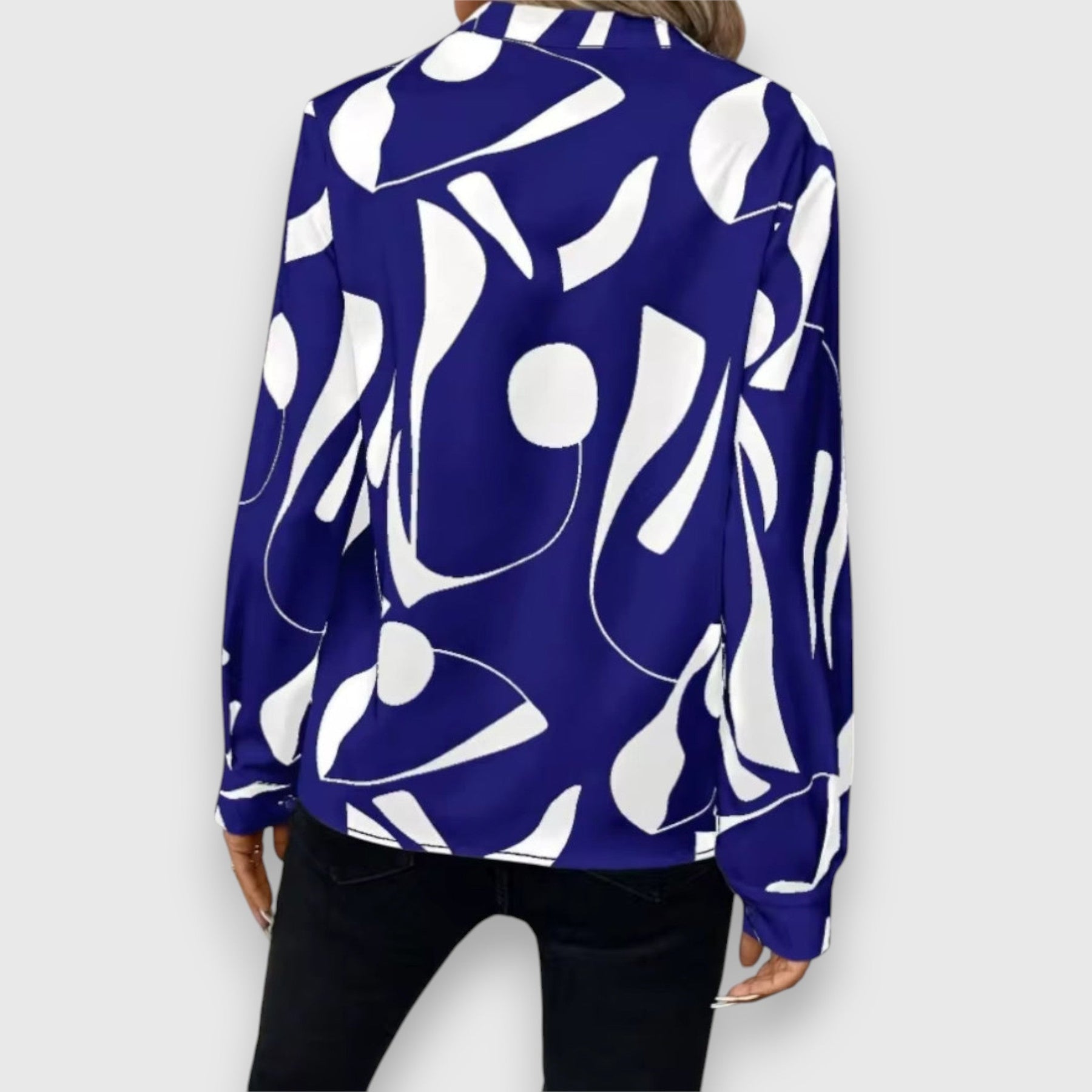 Blue long-sleeve V-neck blouse, back view, bold white abstract pattern
