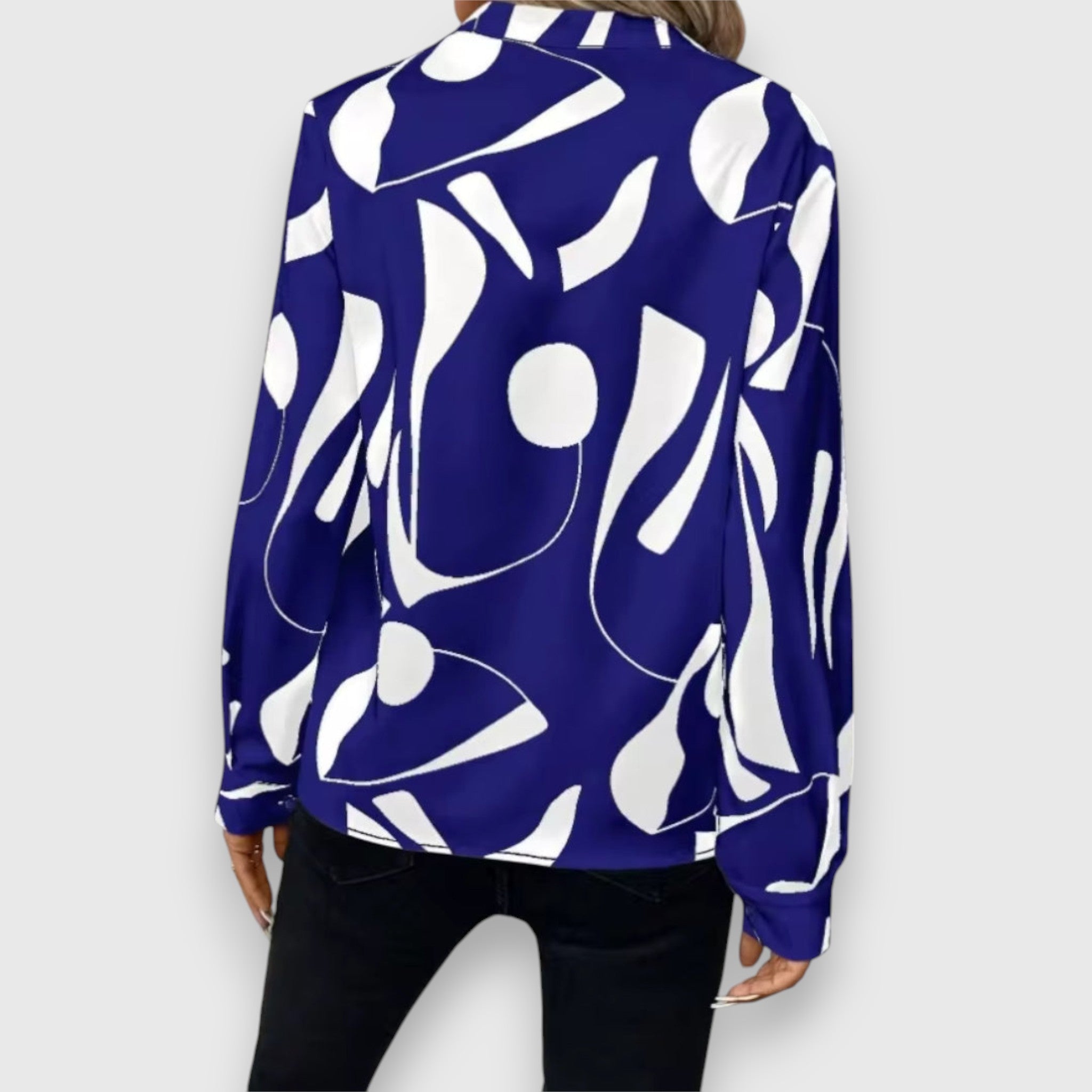 Blue long-sleeve V-neck blouse, back view, bold white abstract pattern