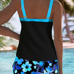 Back view: black tankini top with turquoise straps and blue floral swim shorts.