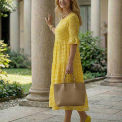 Yellow polka dot tiered midi dress in full view with short sleeves and tiered skirt