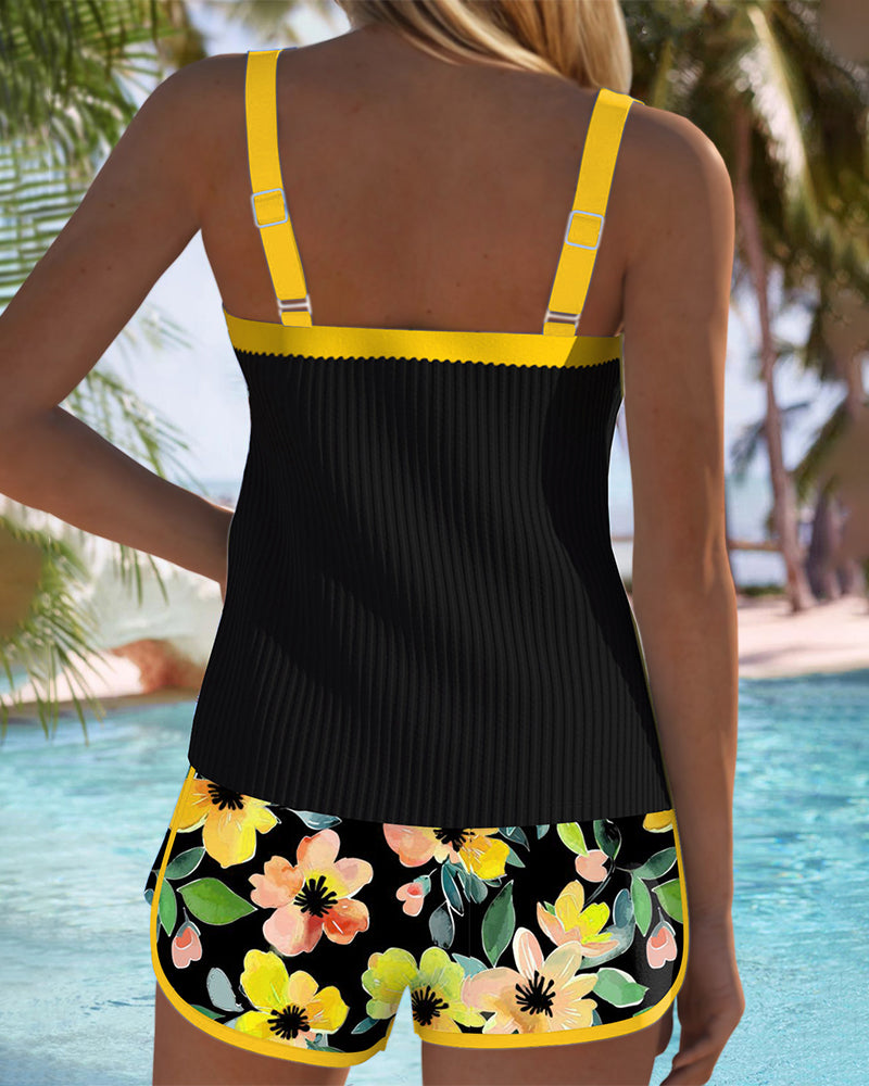 Back view of two-piece tankini set: black tank with yellow straps, floral shorts