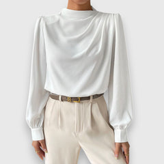 White long-sleeve blouse with high neck, cuffed sleeves, and draped front